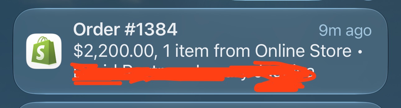 Redacted Shopify notification for order 1384 showing one online-store item and a value of $2,200